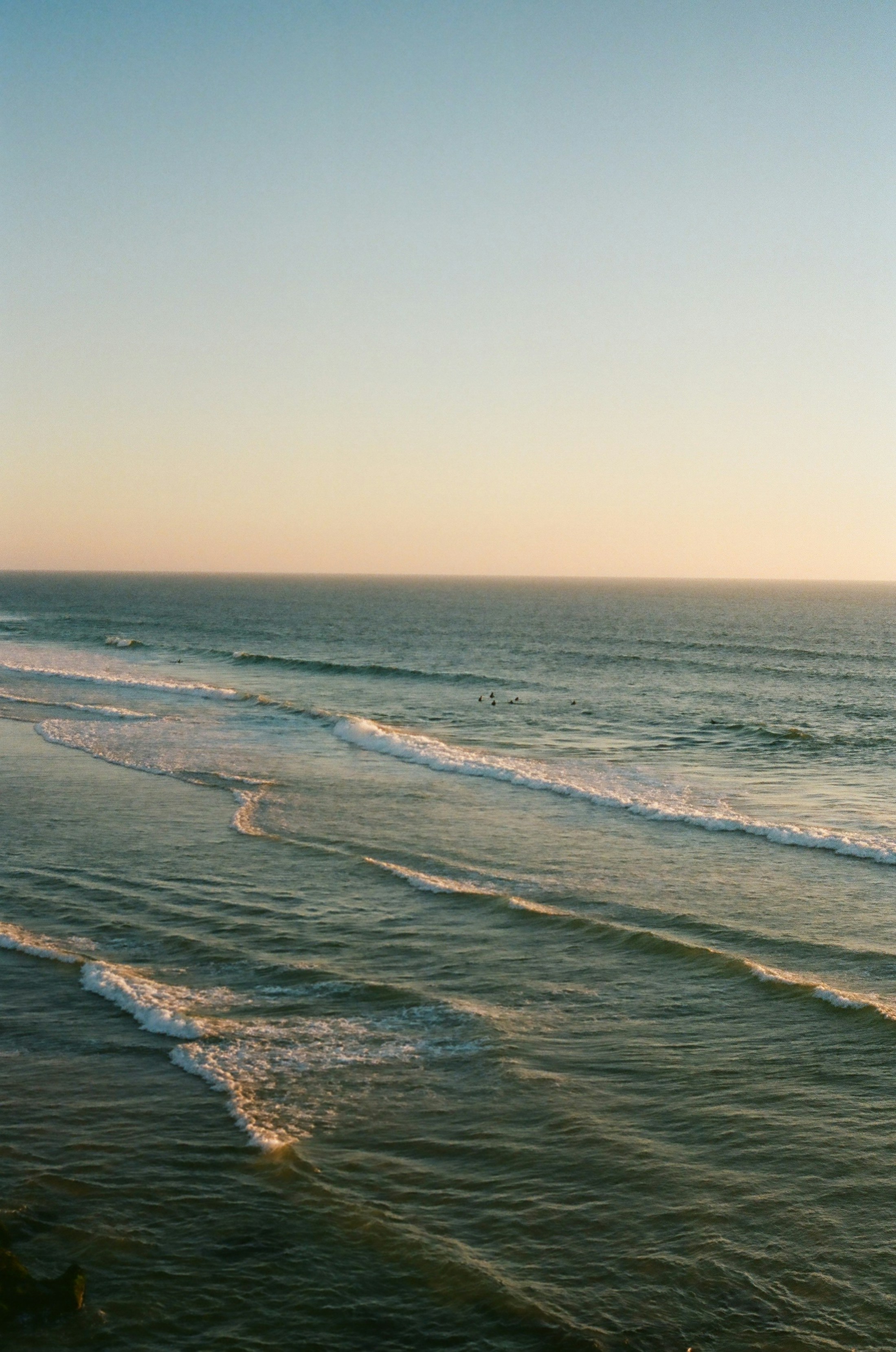 Soft grey waves rolling toward a quiet shore